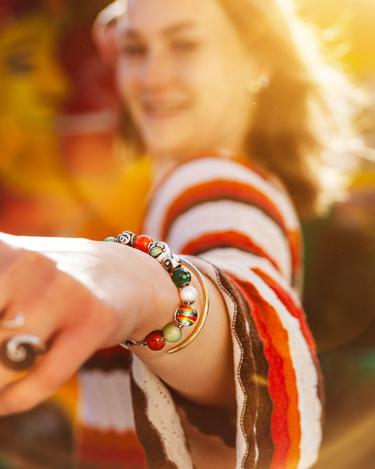 Various round jewellery beads on model wrist in happy summer colours